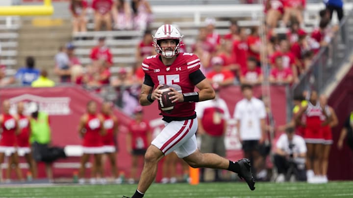 Sep 20, 2025; Madison, Wisconsin, USA;  Wisconsin Badgers quarterback Hunter Simmons (15) rolls out of the pocket during the fourth quarter against the Maryland Terrapins at Camp Randall Stadium. Mandatory Credit: Jeff Hanisch-Imagn Images