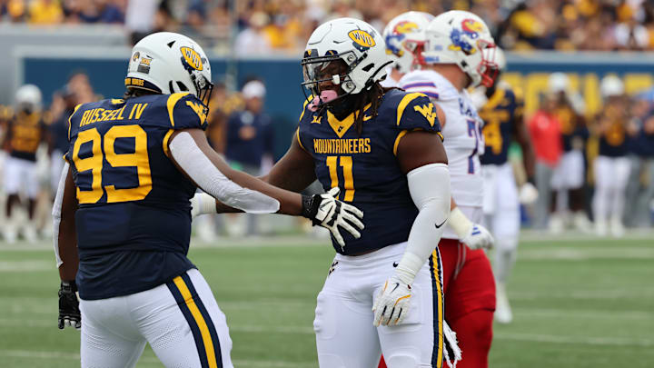 West Virginia University defensive linemen TJ Jackson (11) and Hammond Russell IV. West Virginia University defensive linemen TJ Jackson (11) and Hammond Russell IV.