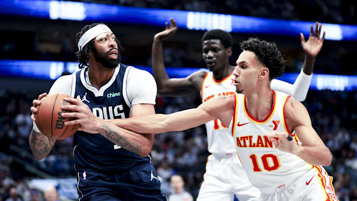 Apr 2, 2025; Dallas, Texas, USA;  Dallas Mavericks forward Anthony Davis (3) looks to pass around Atlanta Hawks forward Zaccharie Risacher (10) during the third quarter at American Airlines Center. Mandatory Credit: Kevin Jairaj-Imagn Images