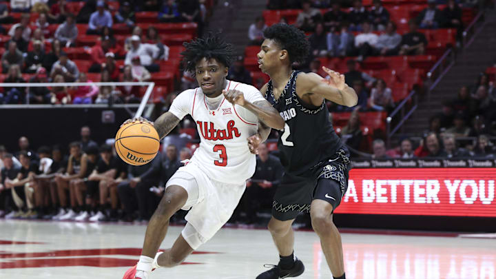 Utah Runnin' Utes guard Don McHenry (3) drives against Colorado Buffaloes guard Isaiah Johnson (2) during the second half at Jon M. Huntsman Center.