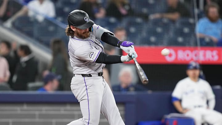Apr 12, 2024; Toronto, Ontario, CAN; Colorado Rockies second baseman Brendan Rodgers (7) hits a triple against the Toronto Blue Jays during the ninth inning at Rogers Centre. Mandatory Credit: Nick Turchiaro-Imagn Images