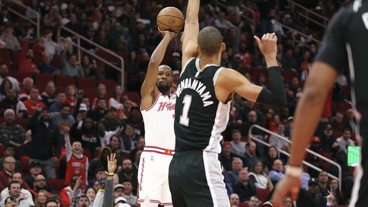Jan 28, 2026; Houston, Texas, USA; Houston Rockets forward Kevin Durant (7) shoots the ball as San Antonio Spurs forward Victor Wembanyama (1) defends during the first quarter at Toyota Center. Mandatory Credit: Troy Taormina-Imagn Images