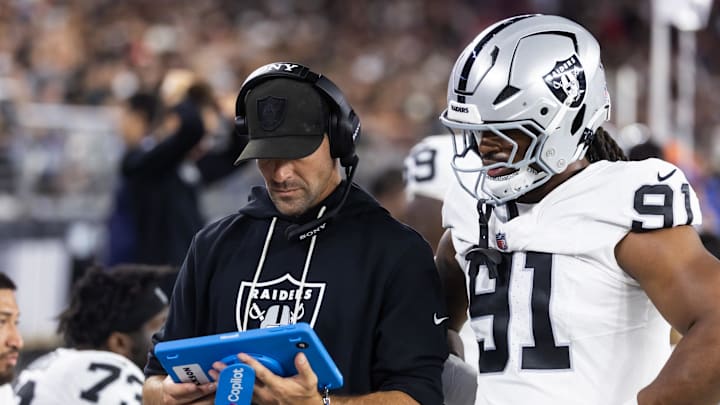 Aug 23, 2025; Glendale, Arizona, USA; Las Vegas Raiders defensive line coach Rob Leonard with defensive end Jahfari Harvey (91) against the Arizona Cardinals during a preseason NFL game at State Farm Stadium. Mandatory Credit: Mark J. Rebilas-Imagn Images Aug 23, 2025; Glendale, Arizona, USA; Las Vegas Raiders defensive line coach Rob Leonard with defensive end Jahfari Harvey (91) against the Arizona Cardinals during a preseason NFL game at State Farm Stadium. Mandatory Credit: Mark J. Rebilas-Imagn Images
