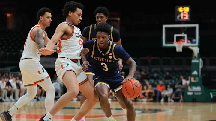 Feb 1, 2025; Coral Gables, Florida, USA; Notre Dame Fighting Irish guard Markus Burton (3) drives to the basket against Miami Hurricanes guard Divine Ugochukwu (99) during the first half at Watsco Center. Mandatory Credit: Sam Navarro-Imagn Images
