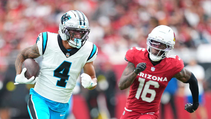 Carolina Panthers wide receiver Tetairoa McMillan (4) runs with the ball during the first quarter against Arizona Cardinals cornerback Max Melton (16) at State Farm Stadium. 