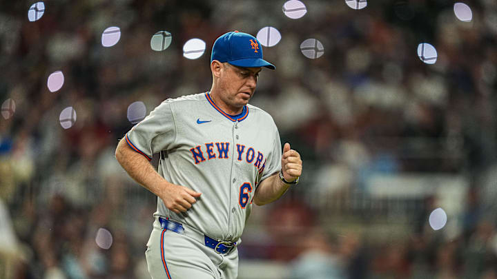 Aug 23, 2025; Cumberland, Georgia, USA; New York Mets manager Carlos Mendoza (64) on the field during the game against the Atlanta Braves during the seventh inning at Truist Park. Mandatory Credit: Dale Zanine-Imagn Images
