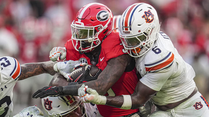 Oct 5, 2024; Athens, Georgia, USA; Georgia Bulldogs running back Nate Frazier (3) is tackled by Auburn Tigers safety Jerrin Thompson (1) and linebacker Austin Keys (6) during the second half at Sanford Stadium. Mandatory Credit: Dale Zanine-Imagn Images Oct 5, 2024; Athens, Georgia, USA; Georgia Bulldogs running back Nate Frazier (3) is tackled by Auburn Tigers safety Jerrin Thompson (1) and linebacker Austin Keys (6) during the second half at Sanford Stadium. Mandatory Credit: Dale Zanine-Imagn Images