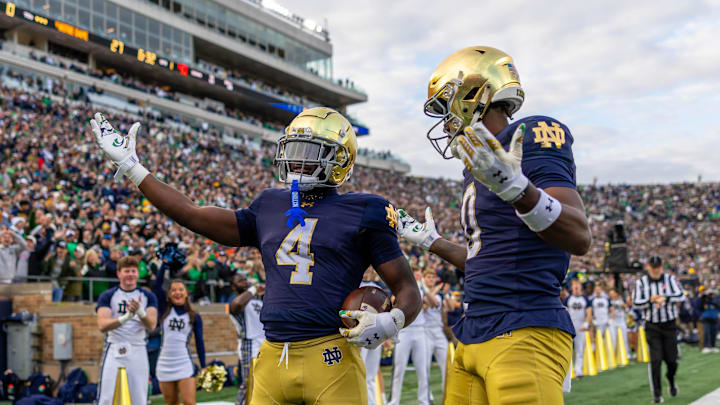 Nov 22, 2025; South Bend, Indiana, USA; Notre Dame Fighting Irish running back Jeremiyah Love (4) celebrates scoring along side Notre Dame Fighting Irish wide receiver Malachi Fields (0) during the first half at Notre Dame Stadium. Mandatory Credit: Michael Caterina-Imagn Images Nov 22, 2025; South Bend, Indiana, USA; Notre Dame Fighting Irish running back Jeremiyah Love (4) celebrates scoring along side Notre Dame Fighting Irish wide receiver Malachi Fields (0) during the first half at Notre Dame Stadium. Mandatory Credit: Michael Caterina-Imagn Images