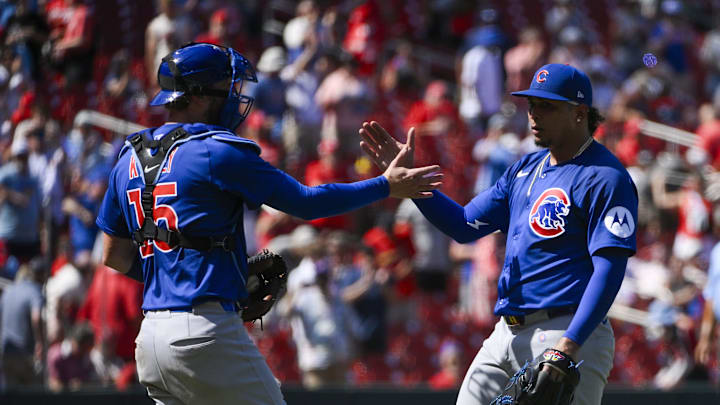 Daniel Palencia (right) celebrates his game-ending strikeout against the Cardinals with Carson Kelly.