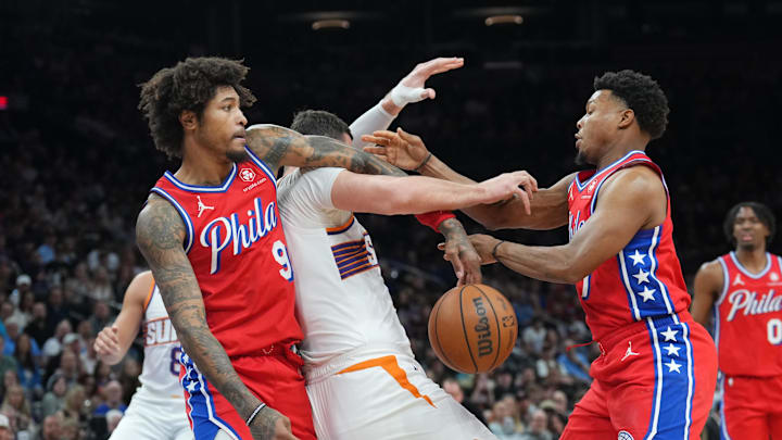 Mar 20, 2024; Phoenix, Arizona, USA; Philadelphia 76ers guard Kelly Oubre Jr. (9) and Philadelphia 76ers guard Kyle Lowry (7) strip the ball from Phoenix Suns center Jusuf Nurkic (20) during the first half at Footprint Center. Mandatory Credit: Joe Camporeale-Imagn Images