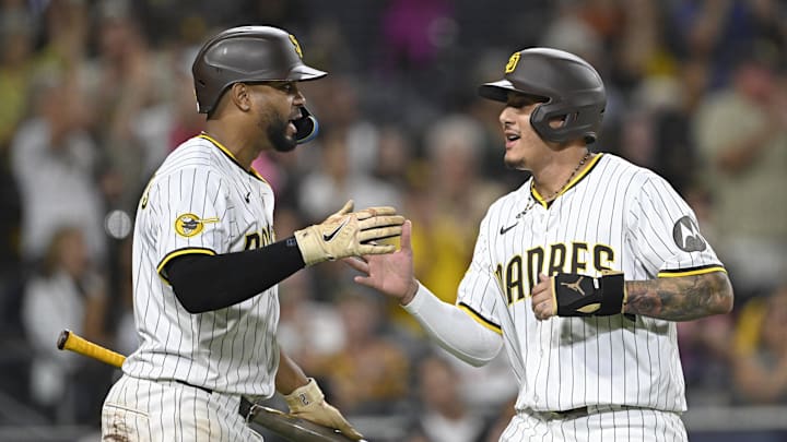 Aug 19, 2025; San Diego, California, USA; San Diego Padres third baseman Manny Machado (13) is congratulated by Xander Bogaerts (2) after scoring during the fifth inning at Petco Park. Mandatory Credit: Denis Poroy-Imagn Images