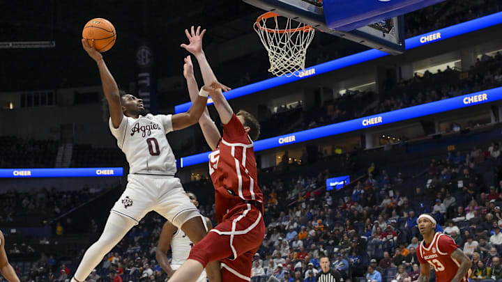 Mar 12, 2026; Nashville, TN, USA;  Texas A&M Aggies guard Marcus Hill (0) shoots over Oklahoma Sooners center Kirill Elantontsev (15) during the first half at Bridgestone Arena. Mandatory Credit: Steve Roberts-Imagn Images