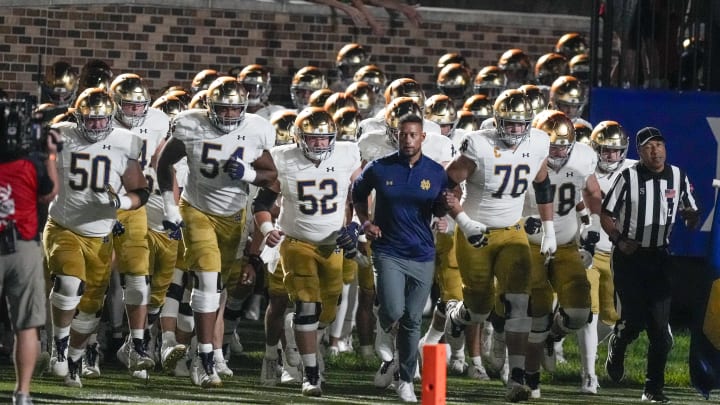 Sep 30, 2023; Durham, North Carolina, USA; Notre Dame Fighting Irish head coach Marcus Freeman leads his team onto the field during the first quarter against the Duke Blue Devils at Wallace Wade Stadium. Sep 30, 2023; Durham, North Carolina, USA; Notre Dame Fighting Irish head coach Marcus Freeman leads his team onto the field during the first quarter against the Duke Blue Devils at Wallace Wade Stadium.