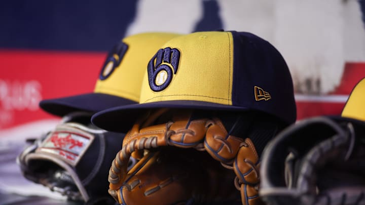 Aug 4, 2025; Atlanta, Georgia, USA; A detailed view of a Milwaukee Brewers hat and glove in the dugout against the Atlanta Braves in the fourth inning at Truist Park. Mandatory Credit: Brett Davis-Imagn Images