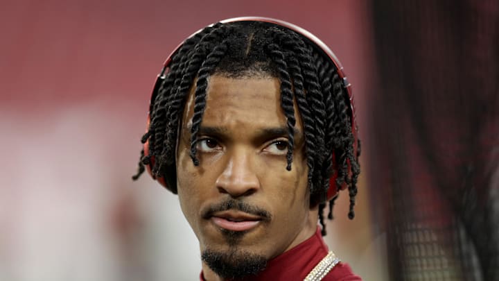 Washington Commanders quarterback Jayden Daniels (5) warms up before a NFC wild card playoff against the Tampa Bay Buccaneers at Raymond James Stadium. 