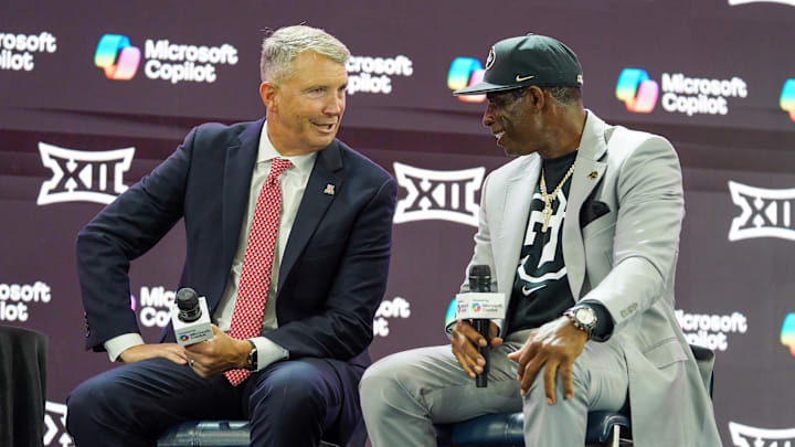 Jul 9, 2025; Frisco, TX, USA; Arizona head coach Brent Brennan and Colorado head coach Deion Sanders talk on stage during 2025 Big 12 Football Media Days at The Star. Mandatory Credit: Raymond Carlin III-Imagn Images