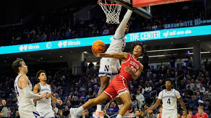 Nov 7, 2025; Evanston, Illinois, USA; Boston University Terriers guard Michael McNair (20) shoots the ball against Northwestern Wildcats forward Arrinten Page (22) (obscured) during the second half at Welsh-Ryan Arena. Mandatory Credit: David Banks-Imagn Images