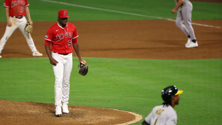 Sep 30, 2023; Anaheim, California, USA; Los Angeles Angels pitcher Jose Soriano (59) reacts after committing a balk with the bases loaded advancing Oakland Athletics center fielder Esteury Ruiz (1) and scoring the game tying run during the eighth inning at Angel Stadium. Mandatory Credit: Kiyoshi Mio-USA TODAY Sports Sep 30, 2023; Anaheim, California, USA; Los Angeles Angels pitcher Jose Soriano (59) reacts after committing a balk with the bases loaded advancing Oakland Athletics center fielder Esteury Ruiz (1) and scoring the game tying run during the eighth inning at Angel Stadium. Mandatory Credit: Kiyoshi Mio-USA TODAY Sports