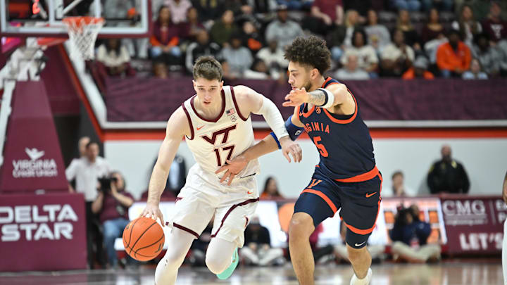 Dec 31, 2025; Blacksburg, Virginia, USA;   Virginia Tech Hokies guard Neoklis Avdalas (17) brings the ball down the court as Virginia Cavaliers guard Sam Lewis (5) defends during the first half at Cassell Coliseum. Mandatory Credit: Brian Bishop-Imagn Images