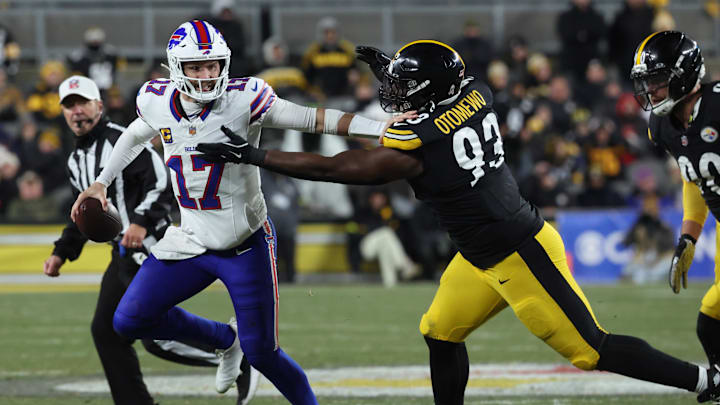 Nov 30, 2025; Pittsburgh, Pennsylvania, USA; Buffalo Bills quarterback Josh Allen (17) stiff arms Pittsburgh Steelers defensive end Esezi Otomewo (93) during the second quarter at Acrisure Stadium. 