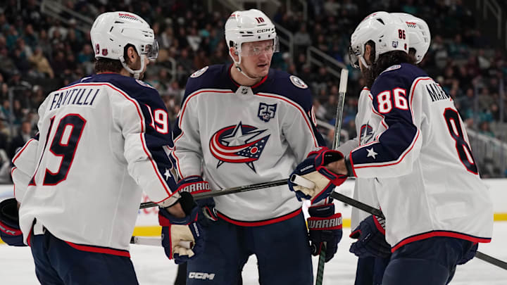 Adam Fantilli, Dmitri Voronkov, and Kirill Marchenko discuss an upcoming faceoff. Adam Fantilli, Dmitri Voronkov, and Kirill Marchenko discuss an upcoming faceoff.