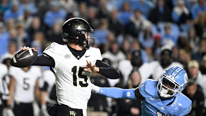 Nov 16, 2024; Chapel Hill, North Carolina, USA; Wake Forest Demon Deacons quarterback Michael Kern (15) looks to pass as North Carolina Tar Heels defensive back Antavious Lane (1) pressures in the third quarter at Kenan Memorial Stadium. Nov 16, 2024; Chapel Hill, North Carolina, USA; Wake Forest Demon Deacons quarterback Michael Kern (15) looks to pass as North Carolina Tar Heels defensive back Antavious Lane (1) pressures in the third quarter at Kenan Memorial Stadium.