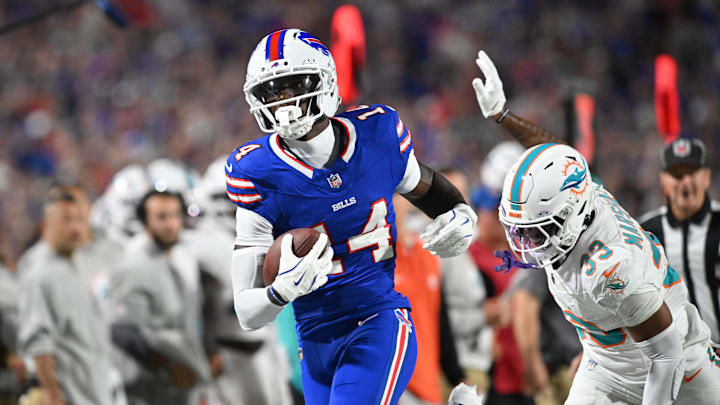 Sep 18, 2025; Orchard Park, New York, USA;  Buffalo Bills wide receiver Tyrell Shavers (14) runs the ball against Miami Dolphins cornerback Jason Marshall Jr. (33) in the first half at Highmark Stadium. 