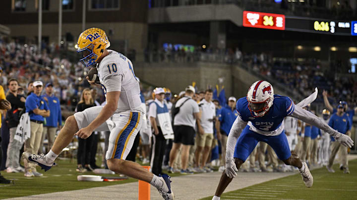 Nov 2, 2024; Dallas, Texas, USA; Pittsburgh Panthers quarterback Eli Holstein (10) scores on a two point conversion against the Southern Methodist Mustangs during the second half at Gerald J. Ford Stadium. Mandatory Credit: Jerome Miron-Imagn Images
