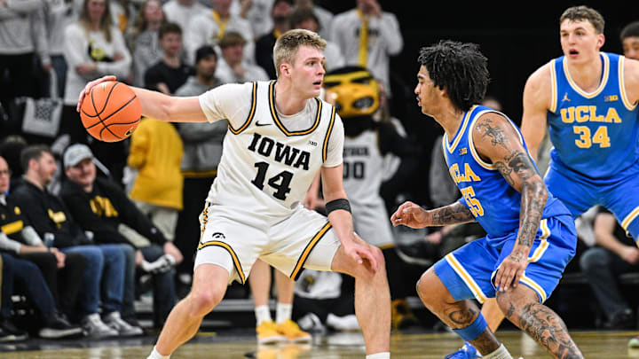 Jan 3, 2026; Iowa City, Iowa, USA; Iowa Hawkeyes guard Bennett Stirtz (14) is defended by UCLA Bruins guard Skyy Clark (55) during the first half at Carver-Hawkeye Arena. Mandatory Credit: Jeffrey Becker-Imagn Images