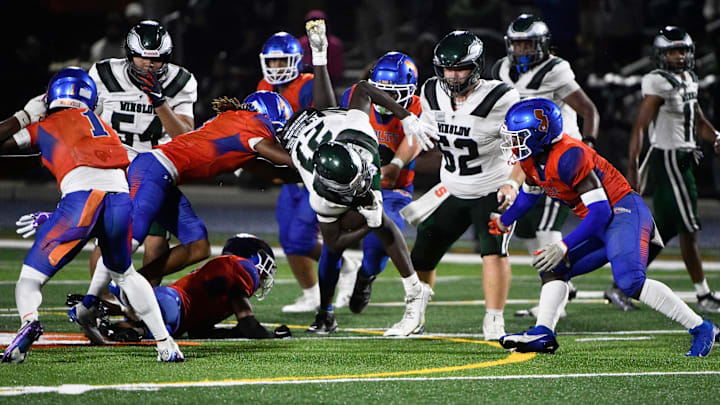 Winslow's NaKeem Powell leaps into the air while running the ball during the football game between Winslow and Millville played at Millville High School on Friday, September 27, 2024.