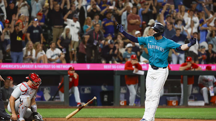 Seattle Mariners right fielder Mitch Haniger (17, right) celebrates after drawing a walk-off walk during the tenth inning against the Philadelphia Phillies at T-Mobile Park. Philadelphia Phillies catcher J.T. Realmuto (10) reacts at left in 2024.