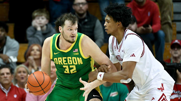 Feb 9, 2026; Bloomington, Indiana, USA; Oregon Ducks center Nate Bittle (32) dribbles against Indiana Hoosiers forward Sam Alexis (4) during the first half at Simon Skjodt Assembly Hall. Feb 9, 2026; Bloomington, Indiana, USA; Oregon Ducks center Nate Bittle (32) dribbles against Indiana Hoosiers forward Sam Alexis (4) during the first half at Simon Skjodt Assembly Hall.