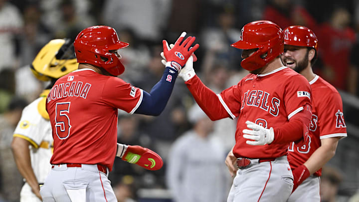 May 12, 2025; San Diego, California, USA; Los Angeles Angels left fielder Taylor Ward (3), right, is congratulated by Yoan Moncada (5) after hitting a grand slam during the ninth inning against the San Diego Padres at Petco Park. Mandatory Credit: Denis Poroy-Imagn Images