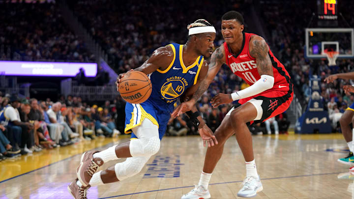 Apr 6, 2025; San Francisco, California, USA; Golden State Warriors forward Jimmy Butler III (10) dribbles past Houston Rockets forward Jabari Smith Jr. (10) in the second quarter at the Chase Center. Mandatory Credit: Cary Edmondson-Imagn Images