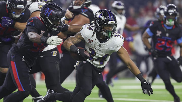 Dec 25, 2024; Houston, Texas, USA;  Baltimore Ravens running back Keaton Mitchell (34) runs with the ball during the fourth quarter against the Houston Texans at NRG Stadium. Mandatory Credit: Troy Taormina-Imagn Images
