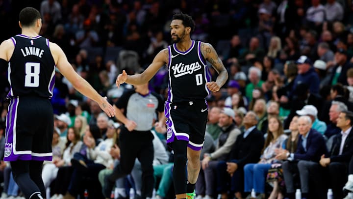 Mar 17, 2025; Sacramento, California, USA; Sacramento Kings guard Malik Monk (0) celebrates with guard Zach LaVine (8) after a scoring a basket during the fourth quarter against the Memphis Grizzlies at Golden 1 Center. Mandatory Credit: Sergio Estrada-Imagn Images