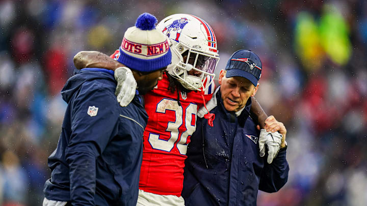 Dec 3, 2023; Foxborough, Massachusetts, USA; New England Patriots running back Rhamondre Stevenson (38) is helped off the field as they take on the Los Angeles Chargers in the second quarter at Gillette Stadium. Mandatory Credit: David Butler II-USA TODAY Sports