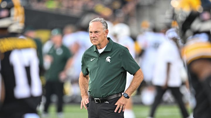Sep 30, 2023; Iowa City, Iowa, USA; Former Michigan State Spartans head coach Mark Dantonio (right) looks on from the field before the game against the Iowa Hawkeyes at Kinnick Stadium. Mandatory Credit: Jeffrey Becker-Imagn Images
