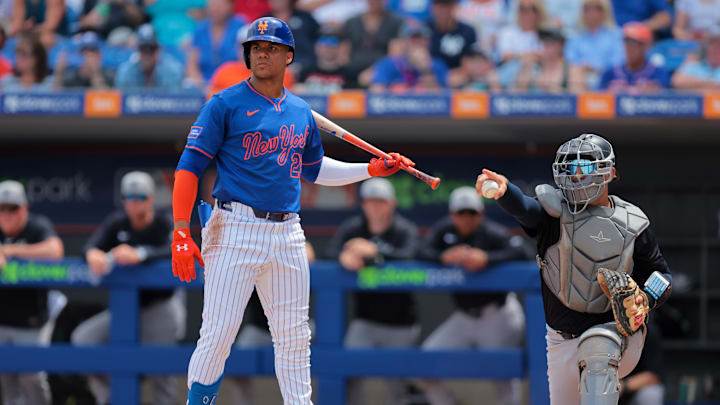 Mar 24, 2025; Port St. Lucie, Florida, USA; New York Mets right fielder Juan Soto (22) looks on toward third base as New York Yankees catcher J.C. Escarra (79) checks for a swing during the first inning at Clover Park. Mandatory Credit: Sam Navarro-Imagn Images