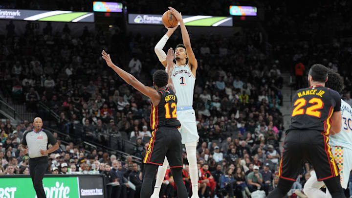 Dec 19, 2024; San Antonio, Texas, USA;  San Antonio Spurs center Victor Wembanyama (1) shoots over Atlanta Hawks forward De'Andre Hunter (12) in the first half at Frost Bank Center. Mandatory Credit: Daniel Dunn-Imagn Images