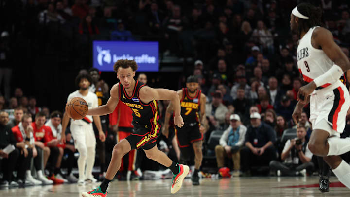 Jan 15, 2026; Portland, Oregon, USA;  Atlanta Hawks guard Dyson Daniels (5) dribbles the ball past Portland Trail Blazers forward Jerami Grant (9) during the second half at Moda Center. Mandatory Credit: Jaime Valdez-Imagn Images