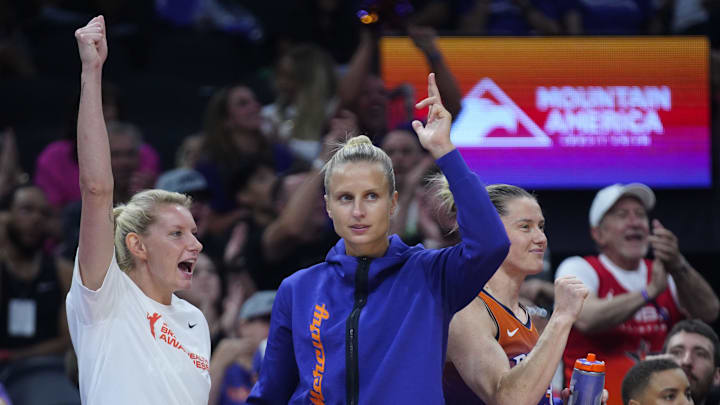 Mercury guards Lexie Held (center white) and Kitija Laska (center purple) celebrate a basket at PHX Arena in Phoenix on Aug. 7, 2025.