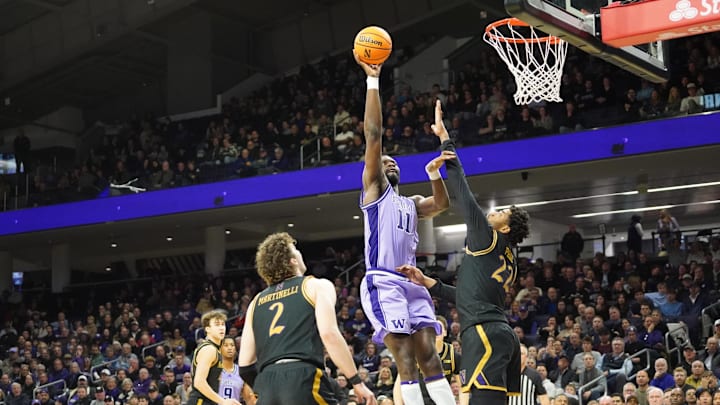 Jan 31, 2026; Evanston, Illinois, USA; Northwestern Wildcats forward Arrinten Page (22) defends Washington Huskies center Franck Kepnang (11) during the second half at Welsh-Ryan Arena. Mandatory Credit: David Banks-Imagn Images