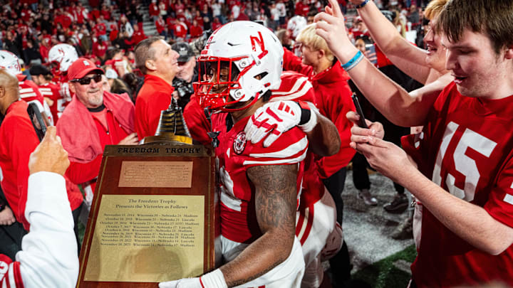 Nov 23, 2024; Lincoln, Nebraska, USA; Nebraska Cornhuskers linebacker Mikai Gbayor (42) walks off with the Freedom Trophy after defeating the Wisconsin Badgers at Memorial Stadium. Mandatory Credit: Dylan Widger-Imagn Images