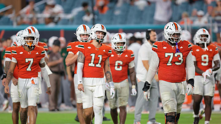 Sep 20, 2025; Miami Gardens, Florida, USA; Miami Hurricanes quarterback Carson Beck (11) and his teammates walk toward the line of scrimmage against the Florida Gators during the fourth quarter at Hard Rock Stadium. Mandatory Credit: Sam Navarro-Imagn Images