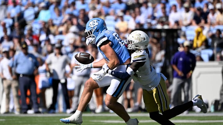 Oct 12, 2024; Chapel Hill, North Carolina, USA; North Carolina Tar Heels tight end John Copenhaver (81) catches the ball as Georgia Tech Yellow Jackets defensive back Omar Daniels (21) defends in the third quarter at Kenan Memorial Stadium. Mandatory Credit: Bob Donnan-Imagn Images