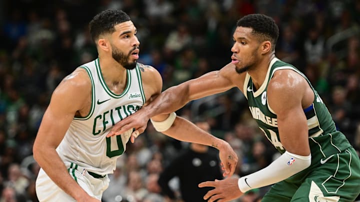 Nov 10, 2024; Milwaukee, Wisconsin, USA; Boston Celtics forward Jayson Tatum (0) and Milwaukee Bucks forward Giannis Antetokounmpo (34) jostle for position in the fourth quarter at Fiserv Forum. Mandatory Credit: Benny Sieu-Imagn Images