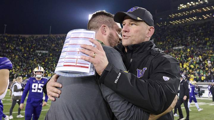 Nov 12, 2022; Eugene, Oregon, USA; Oregon Ducks head coach Dan Lanning congratulates Washington Huskies head coach Kalen DeBoer after a game at Autzen Stadium. The Huskies won the game 37-34. Mandatory Credit: Troy Wayrynen-Imagn Images