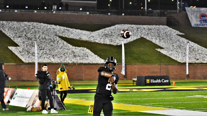 Cardinal Ritter quarterback Carson Boyd warms up before entering the MSHSAA Class 5 State