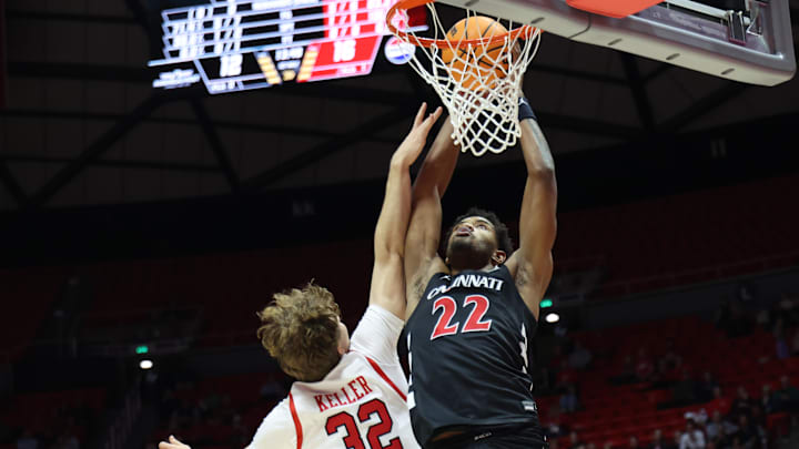 Jan 28, 2025; Salt Lake City, Utah, USA; Cincinnati Bearcats forward Arrinten Page (22) dunks the ball against Utah Utes forward Zach Keller (32) during the first half at Jon M. Huntsman Center. Mandatory Credit: Rob Gray-Imagn Images